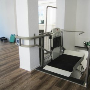 Platform lift in a rehabilitation facility promoting handicap accessibility and mobility aid support.