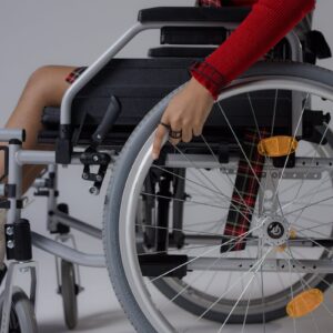 Close-up of a young woman in a wheelchair indoors, highlighting accessibility.